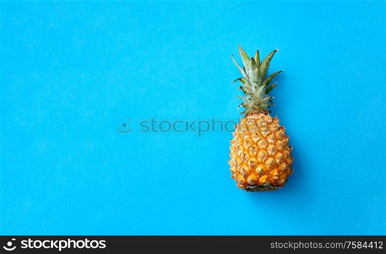 food, fruits and healthy eating concept - close up of pineapple on blue background. close up of pineapple on blue background