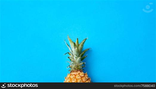 food, fruits and healthy eating concept - close up of pineapple on blue background. close up of pineapple on blue background