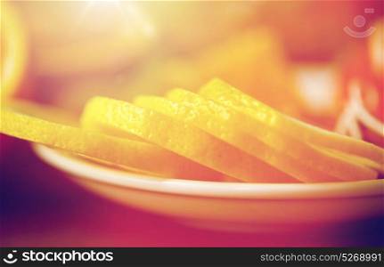food, health, traditional medicine, folk remedy and ethnoscience concept - close up of lemon slices on plate. close up of lemon slices on plate