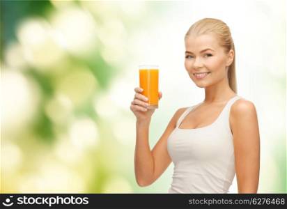 food, healthcare and diet concept - smiling young woman holding glass of orange juice