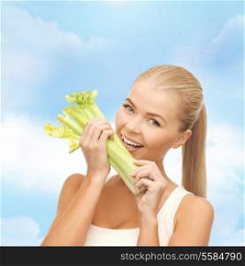 food, healthcare and diet concept - woman biting piece of celery or green salad
