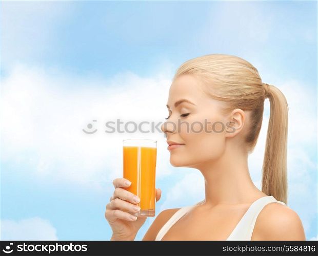 food, healthcare and diet concept - young woman drinking orange juice