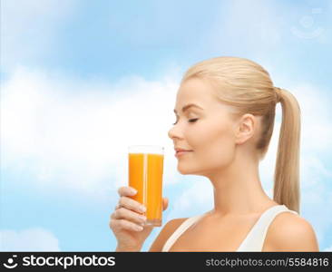 food, healthcare and diet concept - young woman drinking orange juice