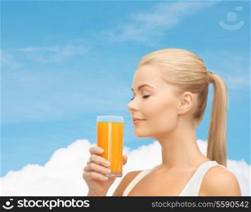 food, healthcare and diet concept - young woman drinking orange juice