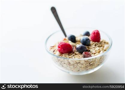 food, healthy eating and diet concept - close up of bowl with granola or muesli on table