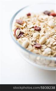 food, healthy eating and diet concept - close up of bowl with granola or muesli on table
