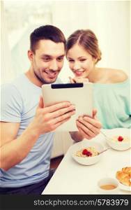 food, home, couple and technology concept - smiling couple with tablet pc reading news or taking picture and having breakfast at home