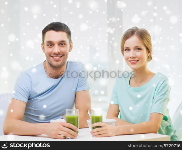 food, home, people and happiness concept - smiling couple having breakfast at home