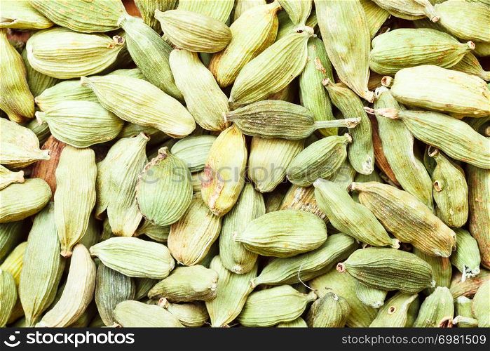 Food indian aroma spice. Green cardamom pods heap as background texture