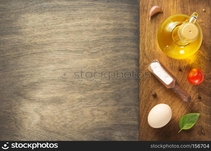 food ingredients and spices at wooden table, top view