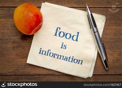 Food is information - handwriting on a napkin with a fresh apricot, diet and healthy lifestyle concept