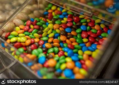 food, junk-food, confectionery and unhealthy eating concept - close up of multicolored dragee candies in box