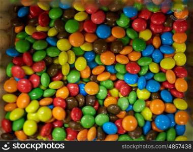 food, junk-food, confectionery and unhealthy eating concept - close up of multicolored dragee candies in box