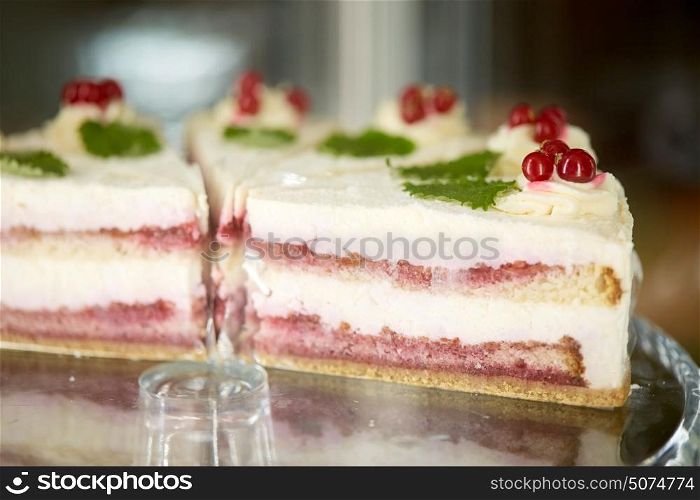 food, junk-food, culinary, baking and dessert concept - pieces of cake on stand. pieces of cake on stand