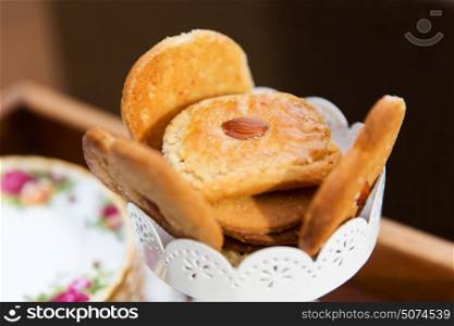 food, junk-food, culinary, baking and eating concept - close up of almond cookies in vase. close up of almond cookies in vase