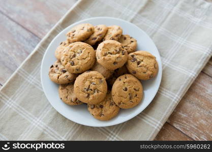 food, junk-food, culinary, baking and eating concept - close up of chocolate oatmeal cookies on plate