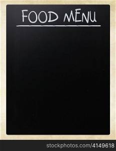 ""Food menu" handwritten with white chalk on a blackboard"