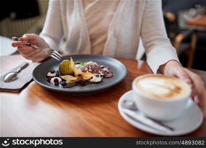 food, new nordic cuisine and people concept - woman eating chocolate ice cream dessert with blueberry kissel, honey baked fig and greek yoghurt with coffee at cafe