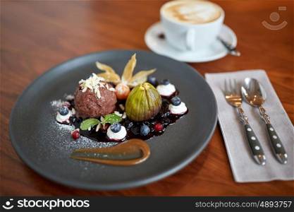 food, new nordic cuisine and sweets concept - chocolate ice cream dessert with blueberry kissel, honey baked fig and greek yoghurt on plate at restaurant
