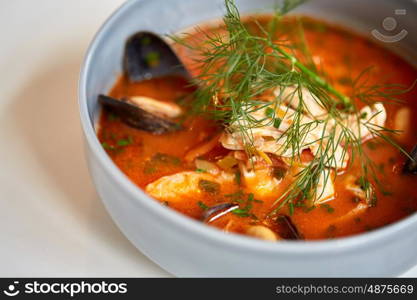 food, new nordic cuisine, culinary and cooking concept - close up of seafood soup with fish and blue mussels in bowl