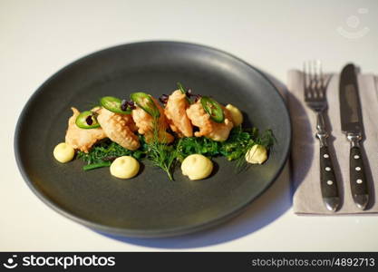 food, new nordic cuisine, culinary and cooking concept - close up of king prawns with jalapeno, wasabi mayonnaise and wakame salad on plate