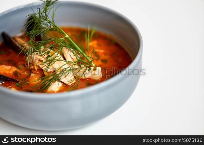 food, new nordic cuisine, culinary and cooking concept - close up of seafood soup with fish and blue mussels in bowl. close up of seafood soup with fish and mussels