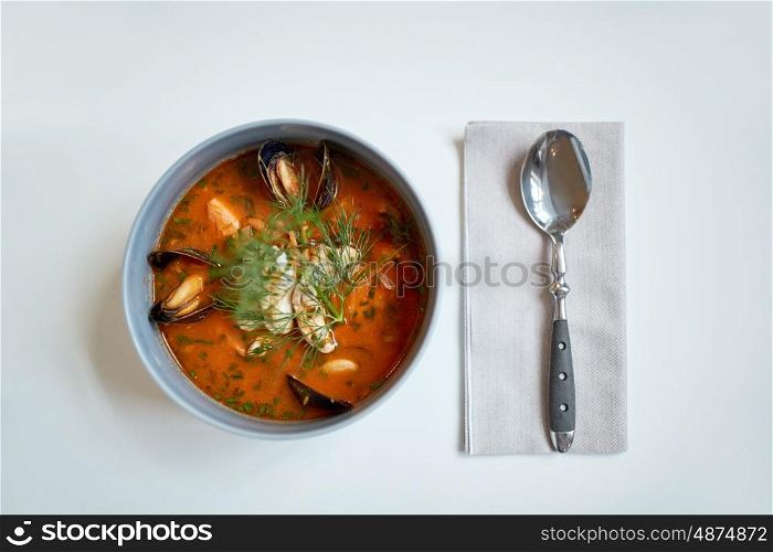 food, new nordic cuisine, culinary and cooking concept - seafood soup with fish and blue mussels in bowl