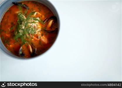 food, new nordic cuisine, culinary and cooking concept - seafood soup with fish and blue mussels in bowl