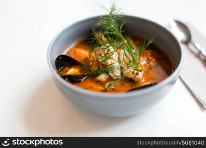 food, new nordic cuisine, culinary and cooking concept - seafood soup with fish and blue mussels in bowl. seafood soup with fish and blue mussels in bowl