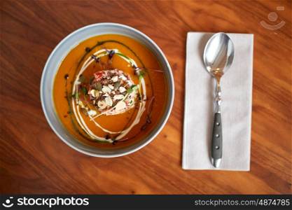 food, new nordic cuisine, culinary and cooking concept - vegetable pumpkin-ginger soup with goat cheese and tomato salad with yogurt in bowl