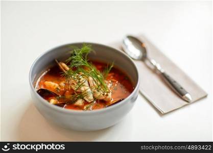 food, new nordic cuisine, dinner, culinary and cooking concept - seafood soup with fish and blue mussels in bowl