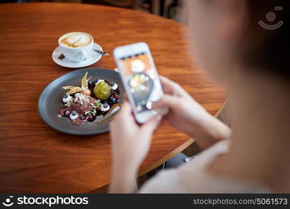 food, new nordic cuisine, technology and people concept - woman with smartphone photographing chocolate ice cream dessert with blueberry kissel, honey baked fig and greek yoghurt at cafe. woman with smartphone photographing food at cafe