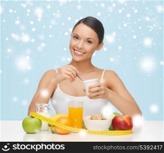 food, nutrition, slimming, diet concept - young woman with healthy breakfast and measuring tape