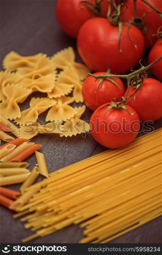 food pasta background . food background on rustic wood with pasta and tomatoes