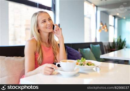food, people and leisure concept - happy woman drinking coffee at restaurant and calling on smartphone. woman with coffee calling smartphone at restaurant