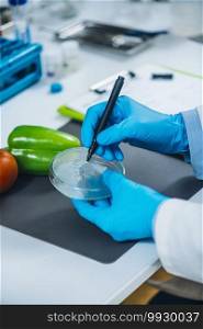 Food safety and quality analysis in a specialized microbiology laboratory, microbiologist working with fruit and vegetable s&les. Food Safety and Quality Control Analysis in a Specialized Microbiology Laboratory