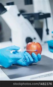 Food Safety Laboratory Analysis - Biochemist looking for presence of pesticides in apples. Food Safety Laboratory Analysis - Biochemist looking for presence of pesticides in apples
