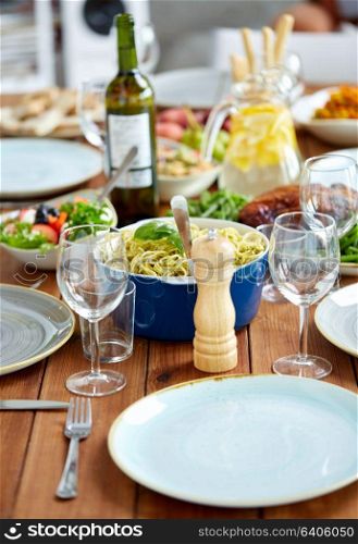 food, seasoning and eating concept - pepper mill or salt grinder on served wooden table. pepper mill or salt grinder on table with food