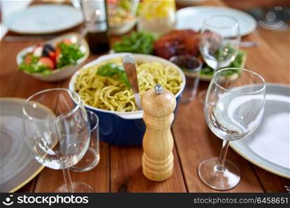 food, seasoning and eating concept - pepper mill or salt grinder on served wooden table. pepper mill or salt grinder on served wooden table