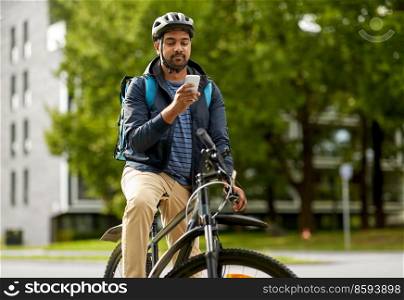 food shipping, profession and people concept - delivery man with thermal insulated bag, smartphone and bicycle on city street. food delivery man with bag, smartphone and bicycle