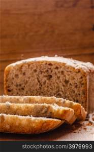 Food. Sliced whole wheat bread on cutting board wooden background