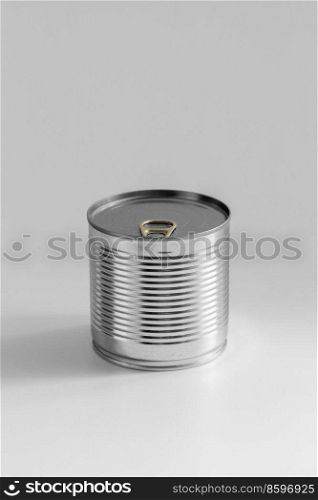 food storage and eating concept - close up of tin can with preserve on table. close up of tin can with preserved food on table