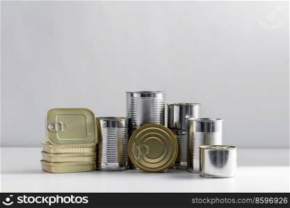 food, storage and preserve concept - close up of tin cans with preserves on table. close up of tin cans with preserved food on table