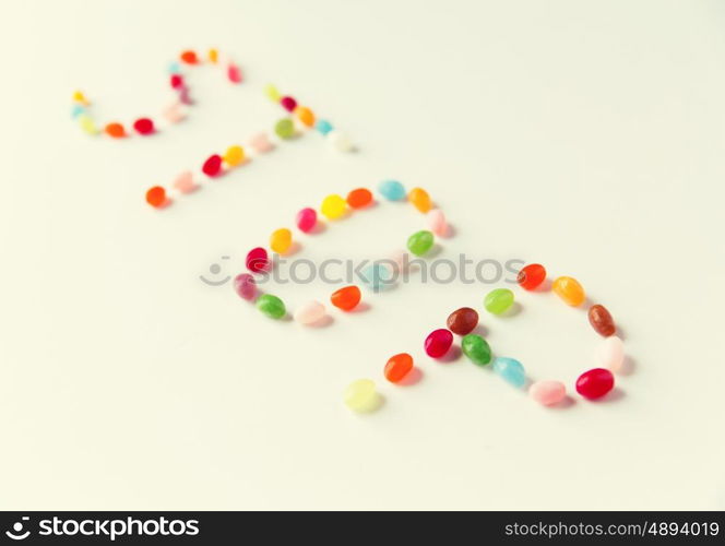 food, sweets, confectionery and unhealthy eating concept - close up of colorful jelly beans candies on table