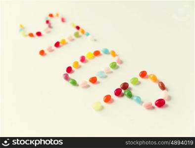 food, sweets, confectionery and unhealthy eating concept - close up of colorful jelly beans candies on table