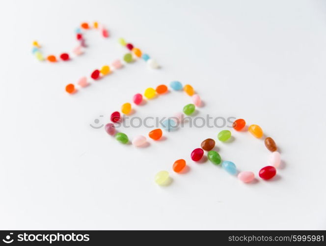 food, sweets, confectionery and unhealthy eating concept - close up of colorful jelly beans candies on table