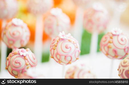 food, sweets, junk-food, confectionery and eating concept - close up of cake pops or lollipops