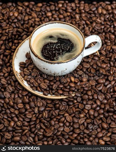 Food und drinks. Black coffee on coffee beans background