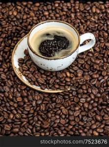 Food und drinks. Black coffee on coffee beans background
