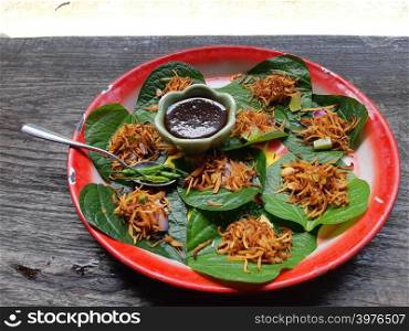 Food wrapped in zinc tray Red leaves nutritious snack thai ancient a walk at the park